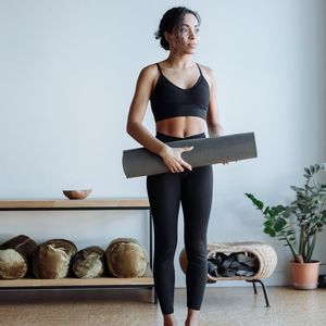 Minimalist yoga studio space with soft lighting and plants.